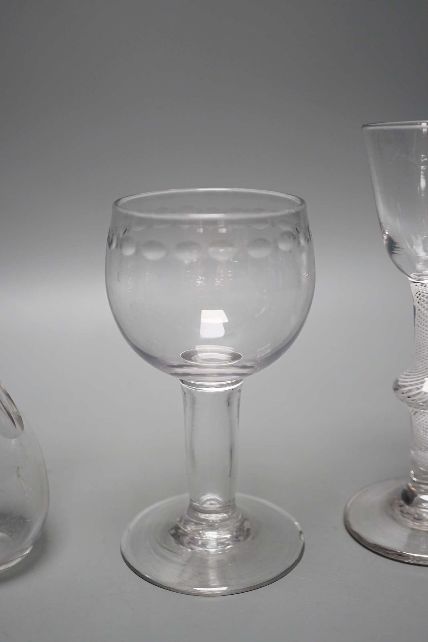 A George II mercury twist stem glass, a George III hollow stem glass, a toddy lifter and an air twist glass, tallest 17cm (4)